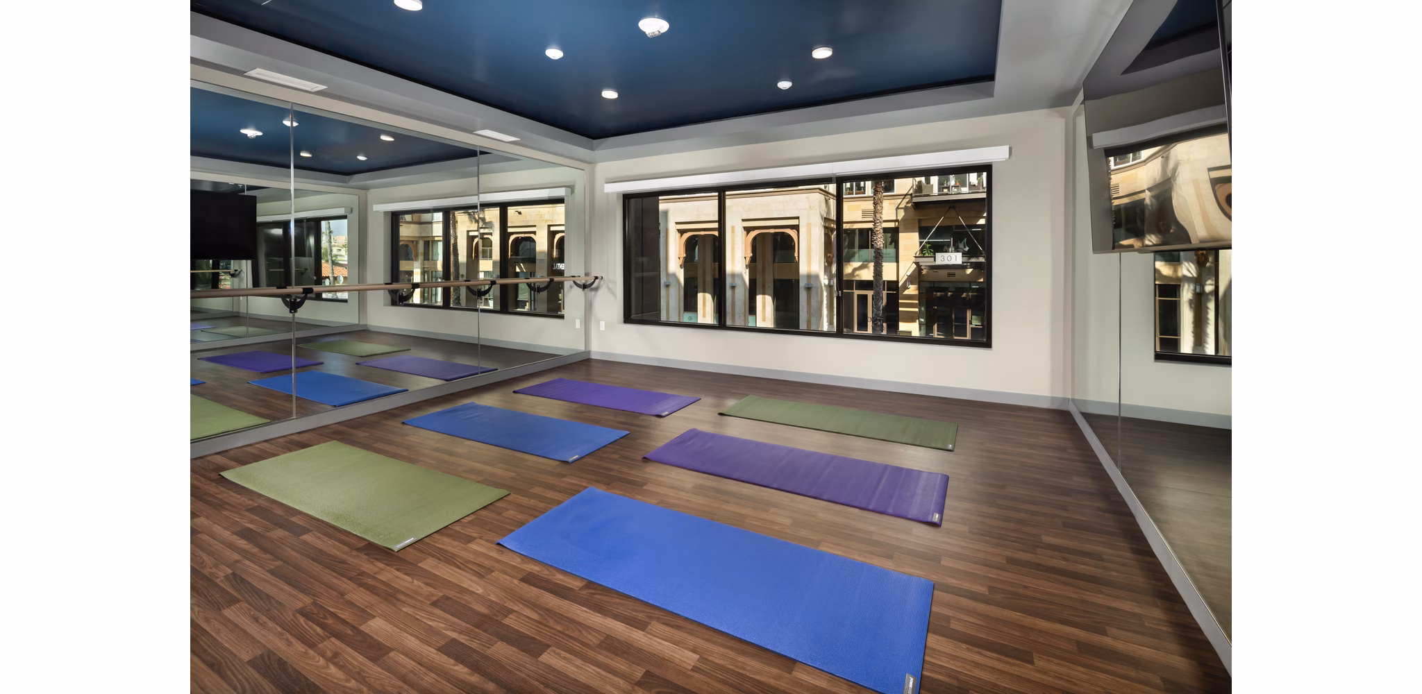 Spacious yoga area with serene decor at Pierside South Apartments, offering tranquil space for residents