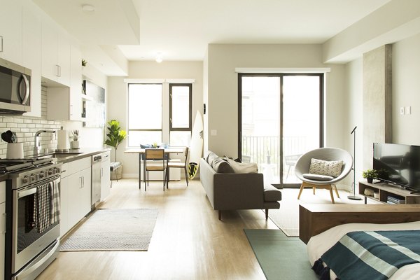 Living room with stylish decor at Pierside South featuring a cozy seating area and modern lighting