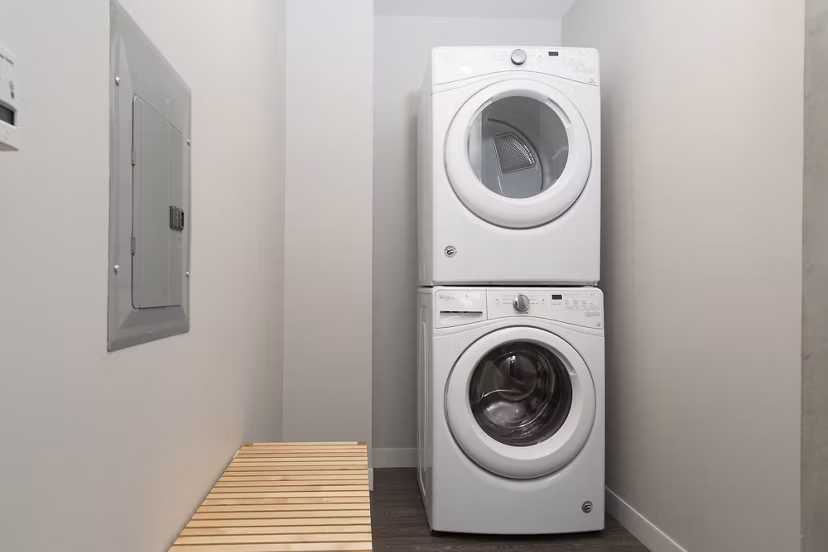 Laundry room with modern appliances at Pierside South luxury apartments