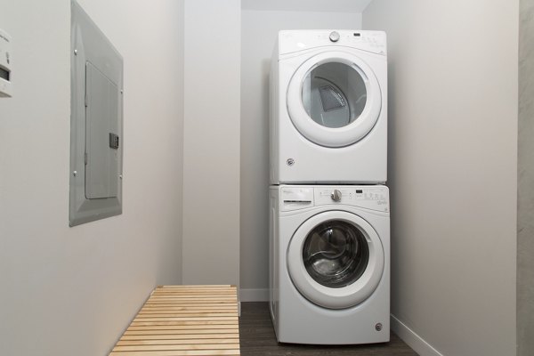 Laundry room with modern appliances at Pierside South luxury apartments