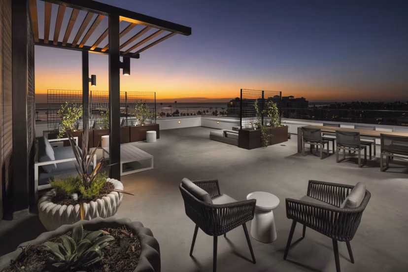 Pierside South Apartments: Inviting patio area with comfortable seating and lush landscaping in a luxury community