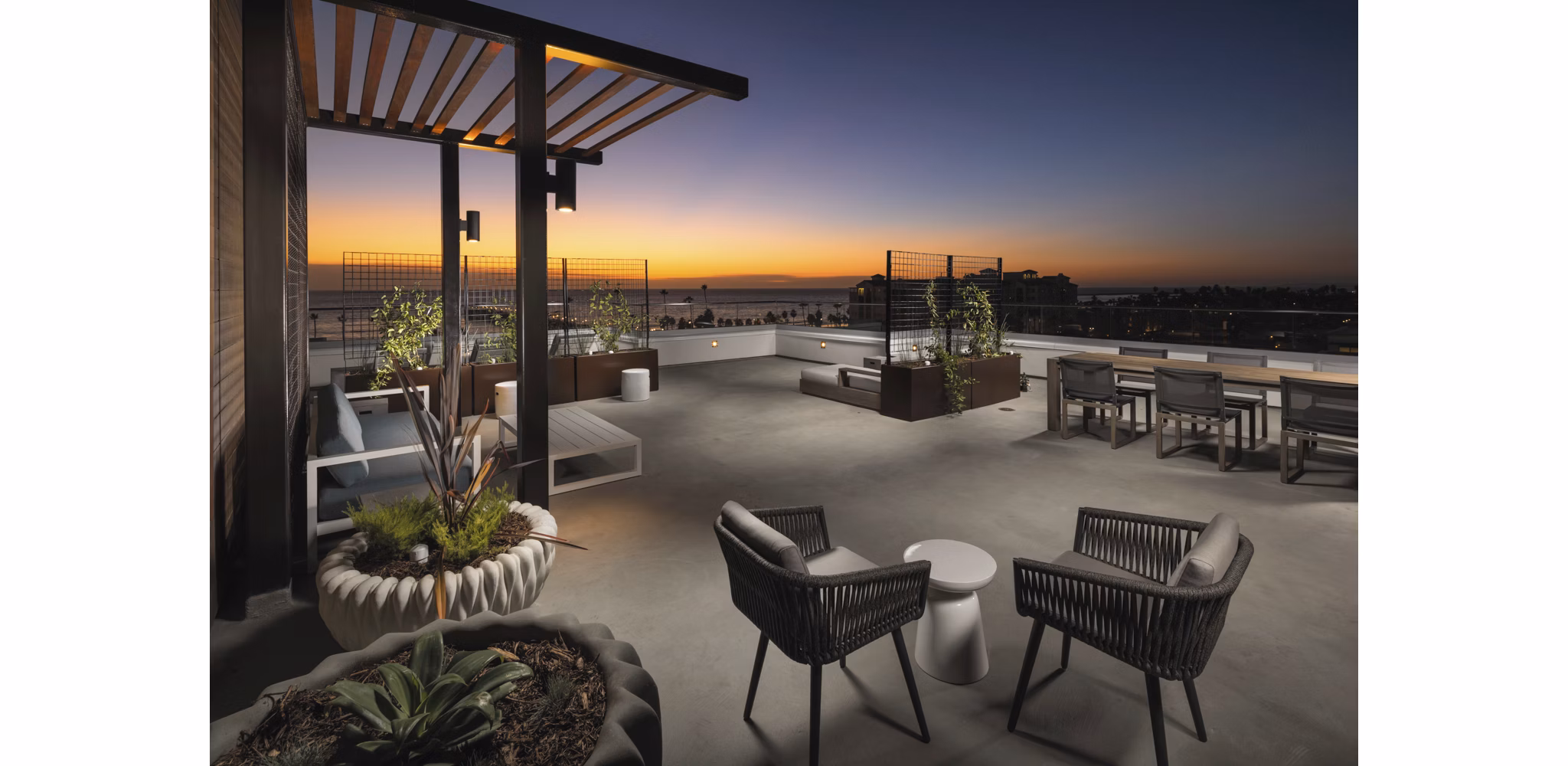 Pierside South Apartments: Inviting patio area with comfortable seating and lush landscaping in a luxury community