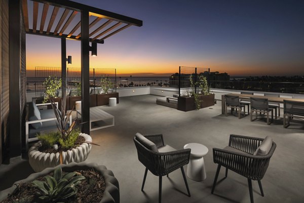 Pierside South Apartments: Inviting patio area with comfortable seating and lush landscaping in a luxury community