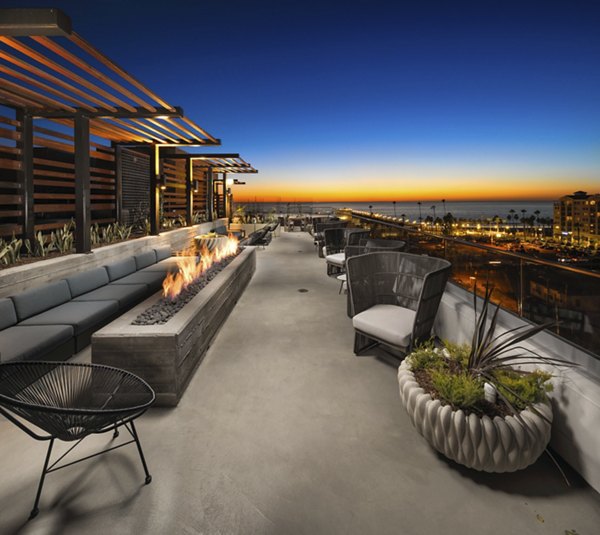 Pierside South Apartments: Stylish patio area with seating and greenery, offering a relaxing outdoor space for residents in coastal community