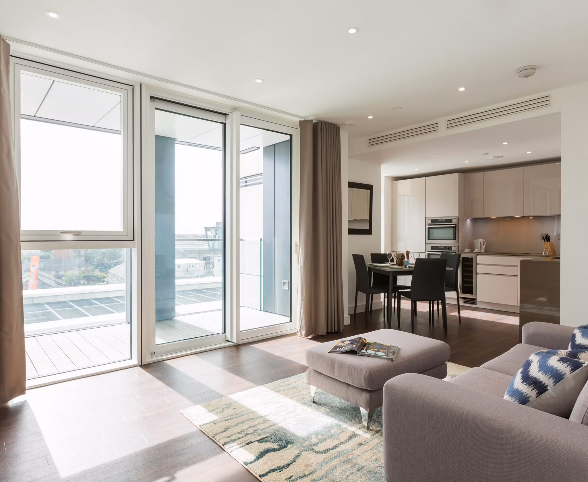 Modern living room with sleek furniture and art at Nine Elms luxury apartments