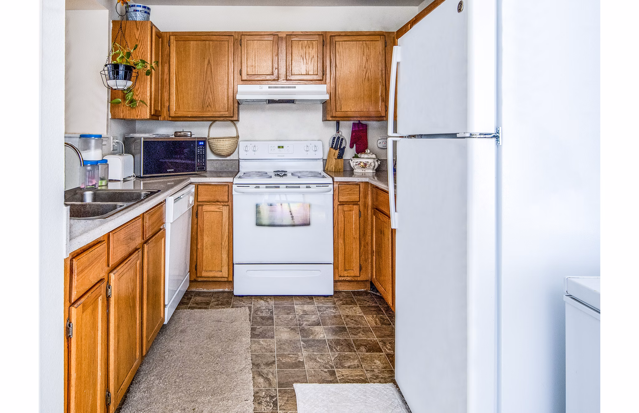 Modern kitchen with stainless steel appliances in Allison Pointe Apartments