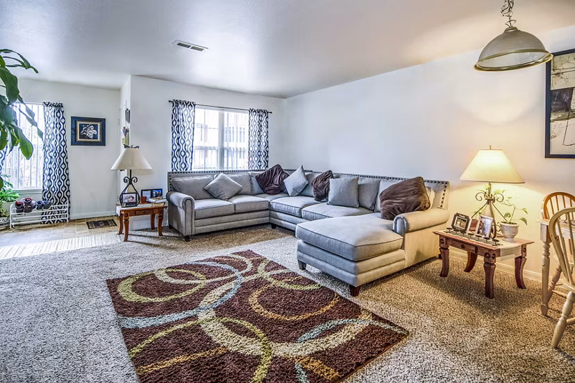 Spacious living room with contemporary furnishings in Allison Pointe Apartments