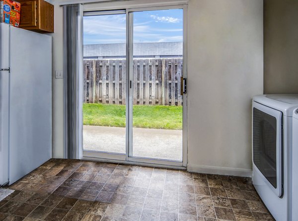 Modern laundry room with high-efficiency washers and dryers at Allison Pointe Apartments