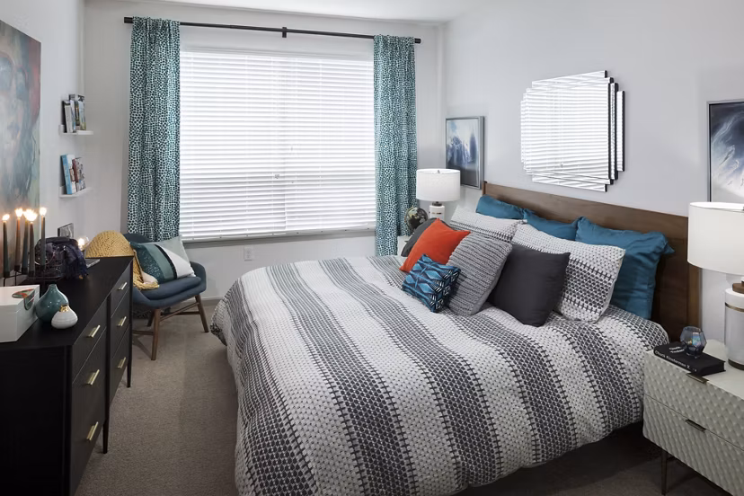 Cozy bedroom with elegant decor in Alexan West Highland luxury apartments