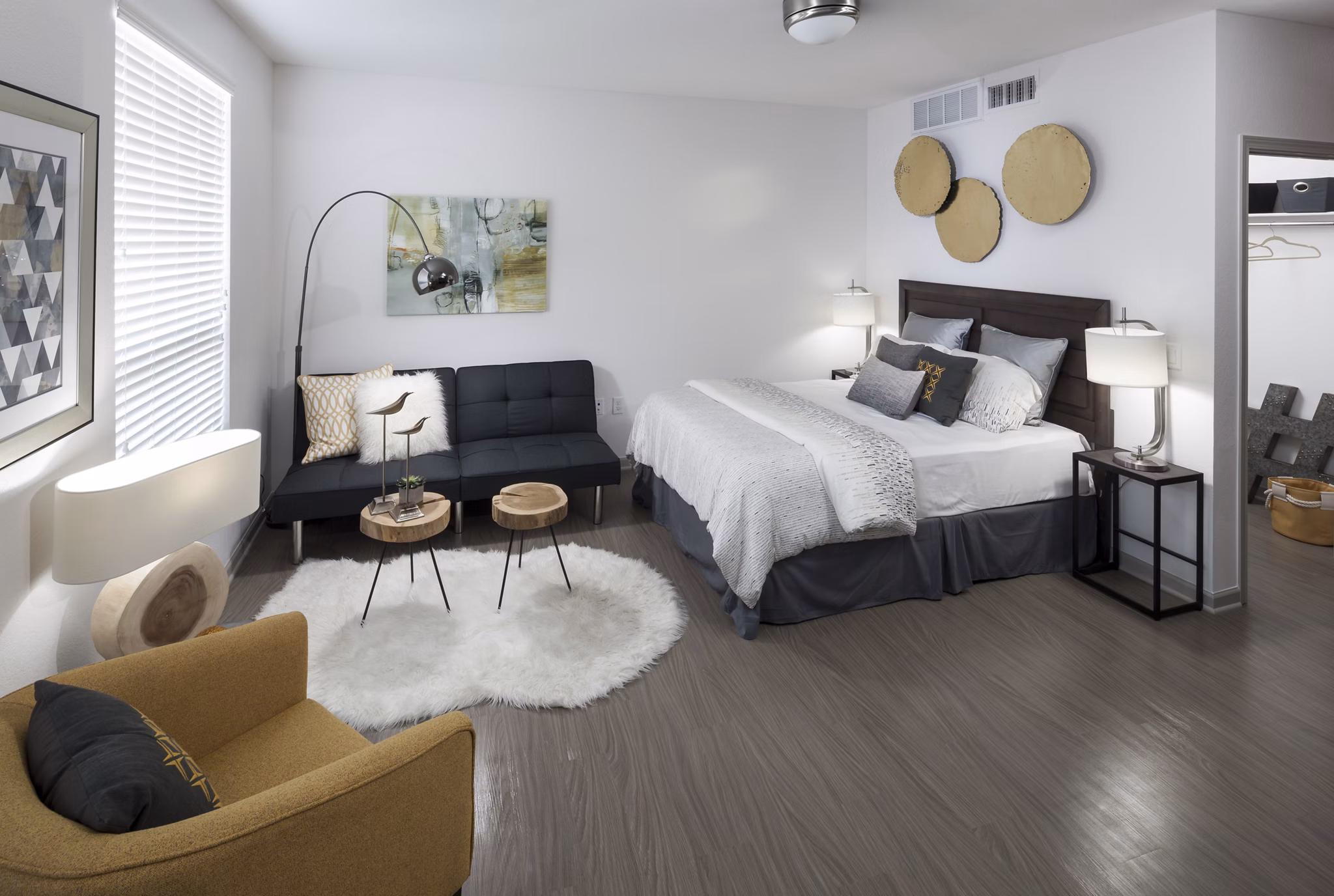 Cozy bedroom featuring a plush queen bed and modern decor at Alexan West Highland apartments