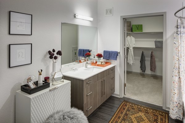 Bathroom featuring sleek fixtures and modern design at Alexan West Highland luxury apartments