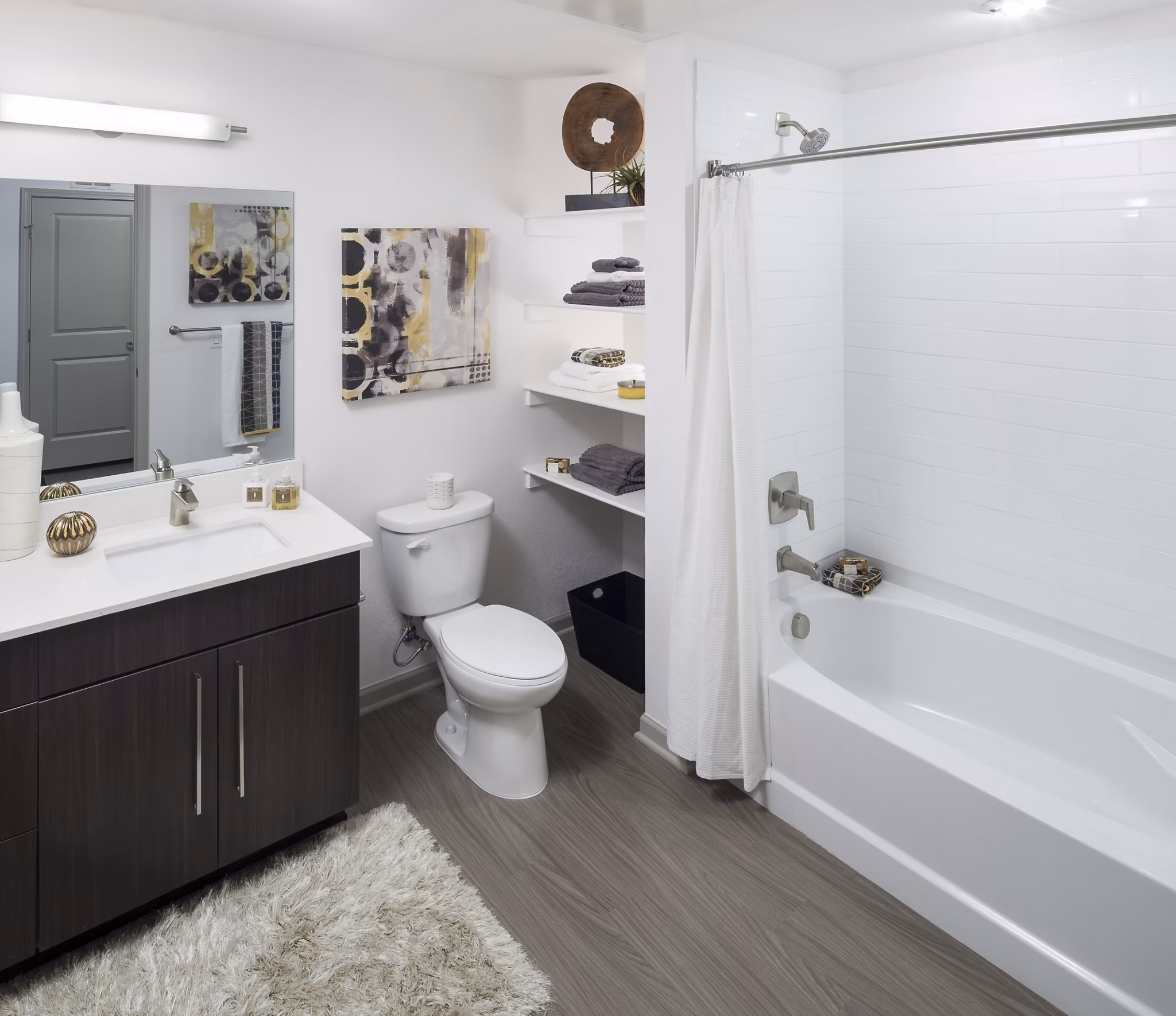 Elegant bathroom with marble countertops and rainfall shower at Alexan West Highland apartments