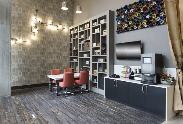Clubhouse with modern decor and comfortable seating at Alexan West Highland luxury apartments