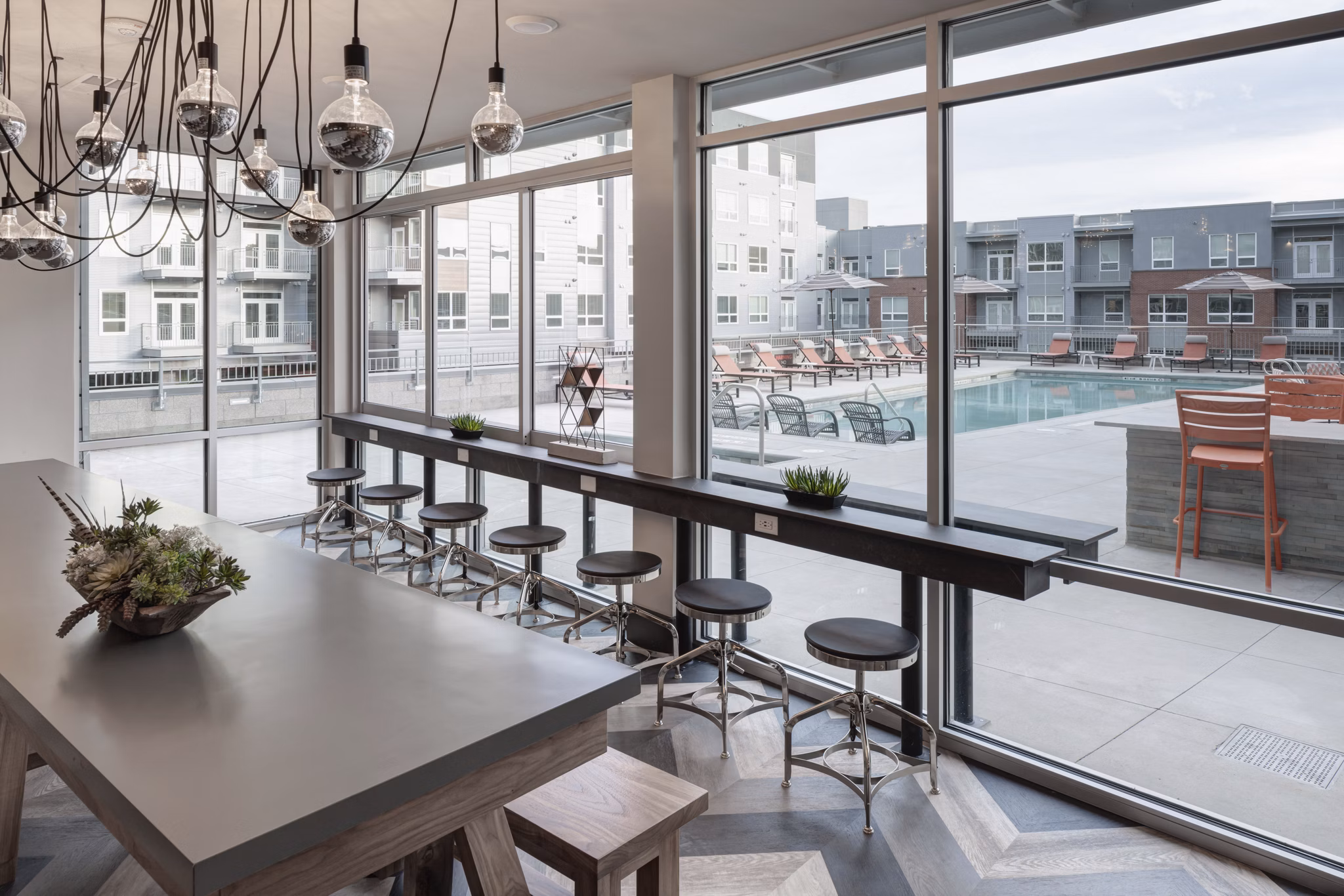 Elegant clubhouse with modern decor at Alexan West Highland luxury apartments, offering community space for gatherings and events