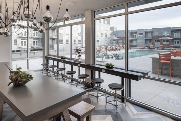 Elegant clubhouse with modern decor at Alexan West Highland luxury apartments, offering community space for gatherings and events