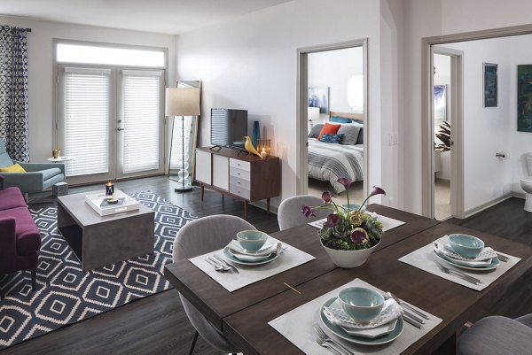 Dining room with sleek furniture and modern lighting at Alexan West Highland luxury apartments