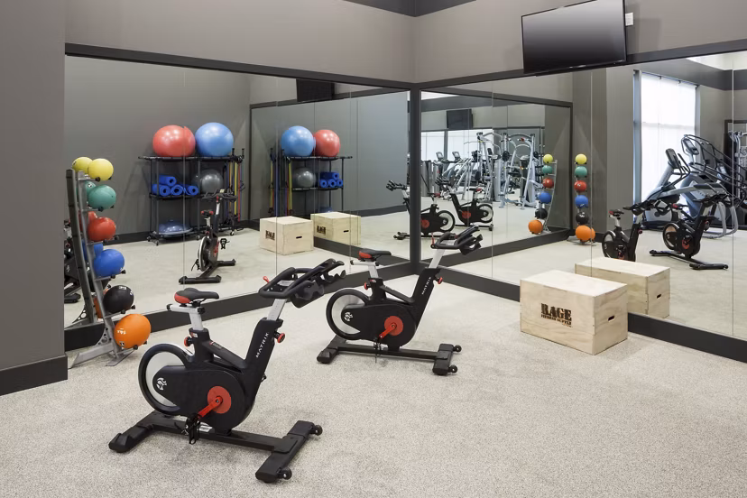 Modern fitness center at Alexan West Highland featuring state-of-the-art equipment and spacious workout areas