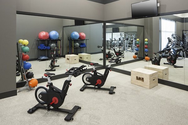 Modern fitness center at Alexan West Highland featuring state-of-the-art equipment and spacious workout areas