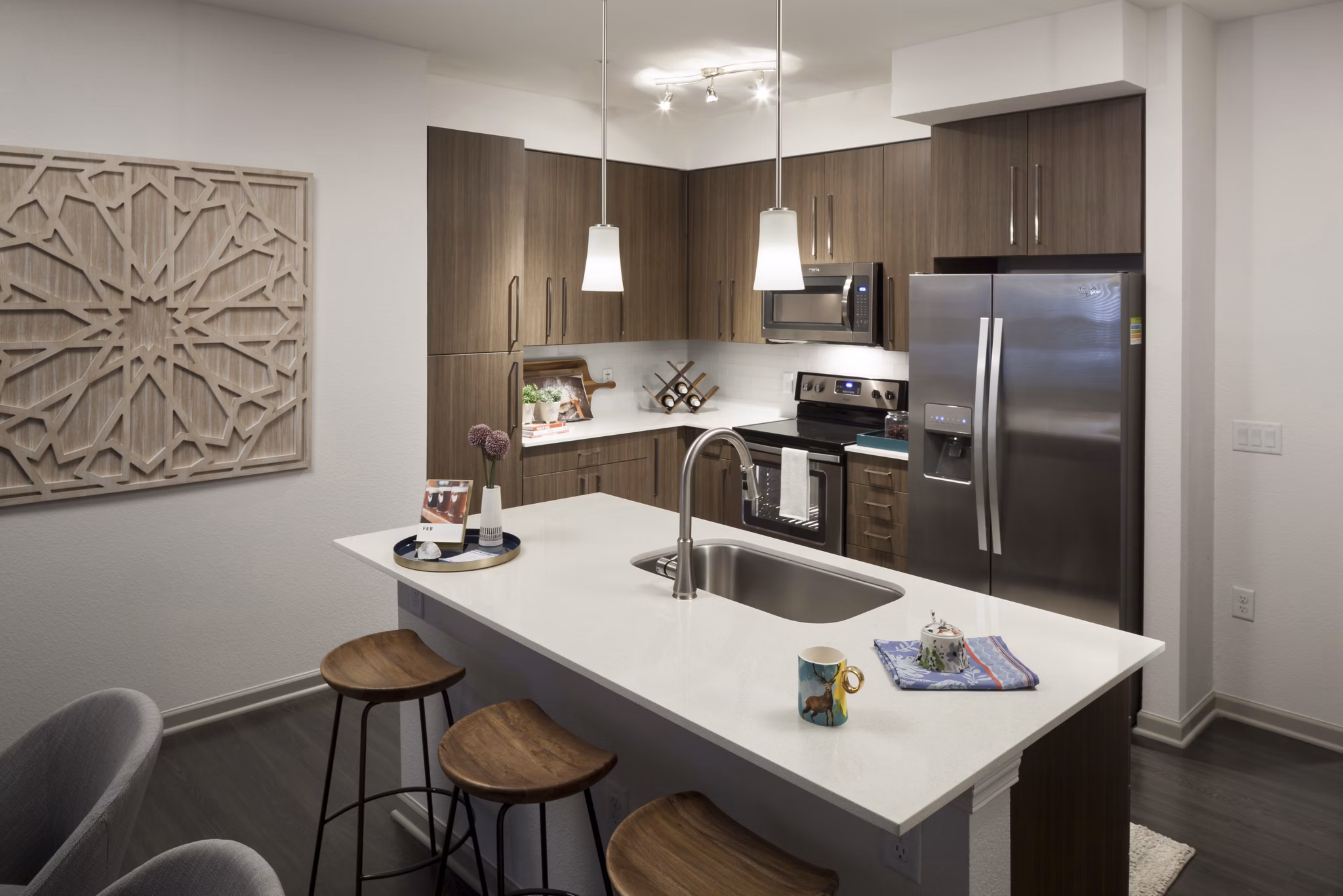 Modern kitchen with stainless steel appliances at Alexan West Highland luxury apartments