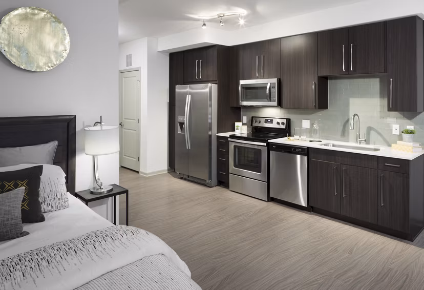 Modern kitchen with stainless steel appliances at Alexan West Highland luxury apartments