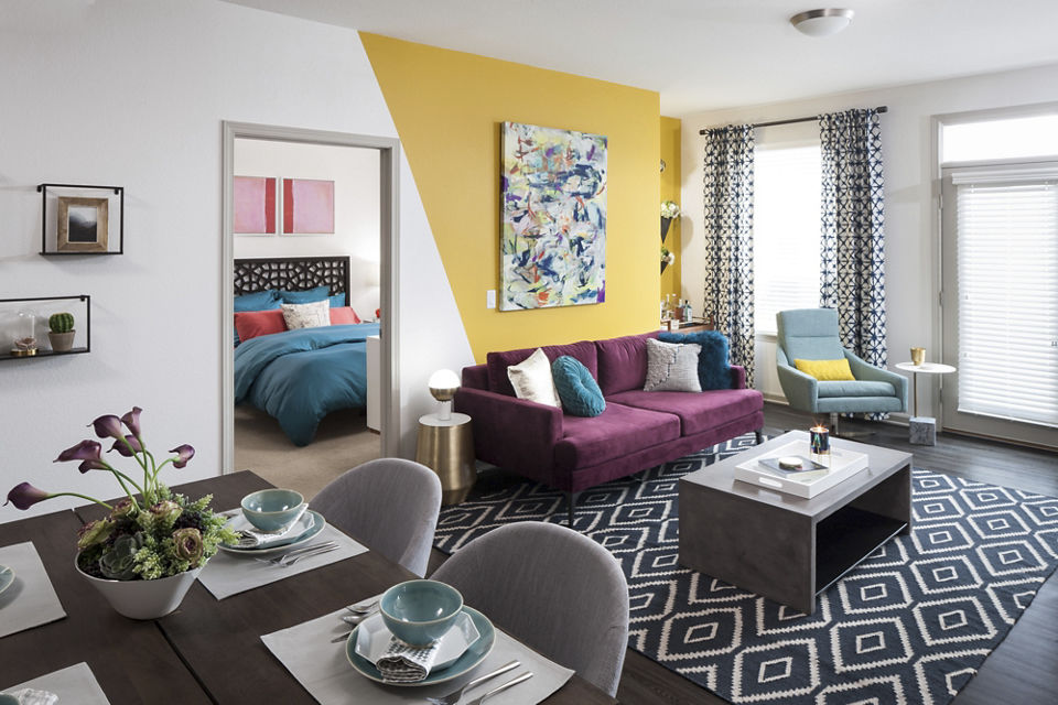 Cozy living room with modern decor at Alexan West Highland luxury apartments