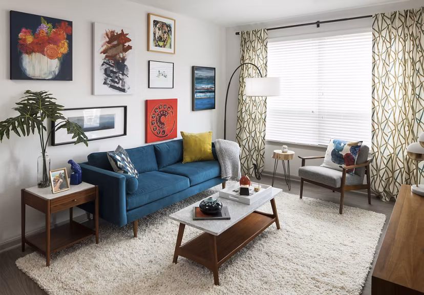 Spacious living room with modern furnishings at Alexan West Highland apartments, ideal for luxury living
