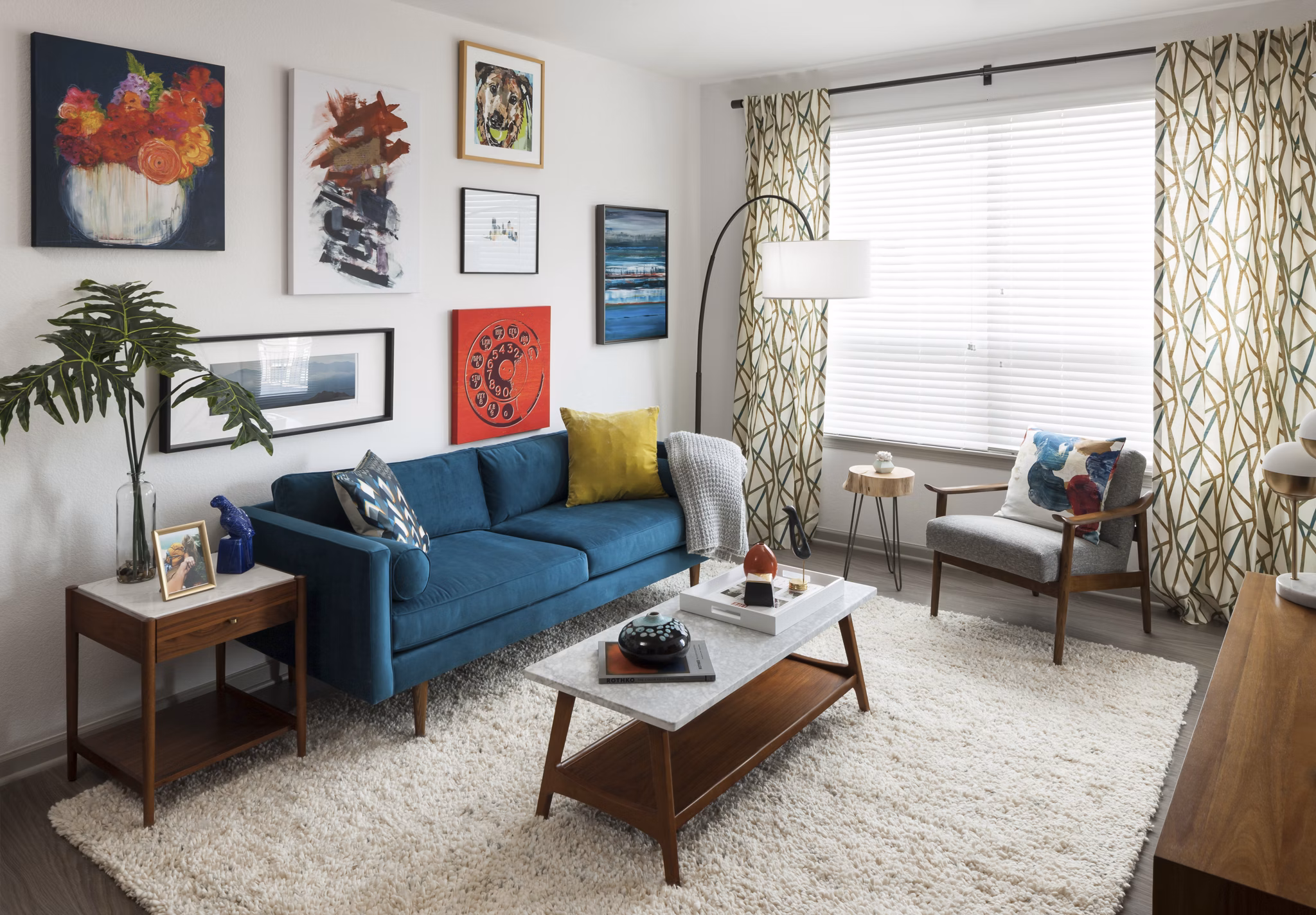 Spacious living room with modern furnishings at Alexan West Highland apartments, ideal for luxury living