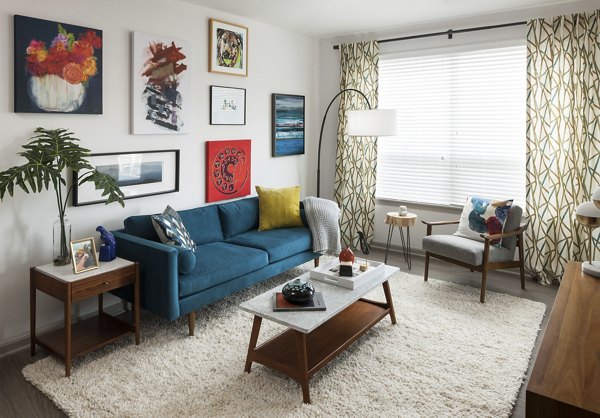 Spacious living room with modern furnishings at Alexan West Highland apartments, ideal for luxury living