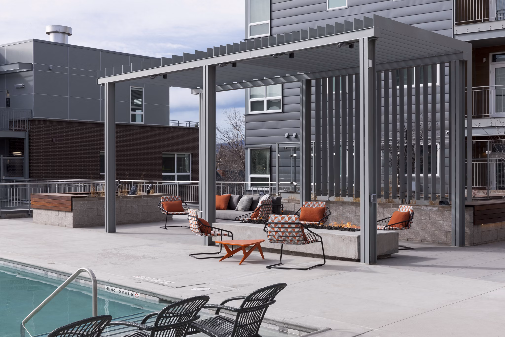 Inviting pool with lounge area at Alexan West Highland luxury apartments