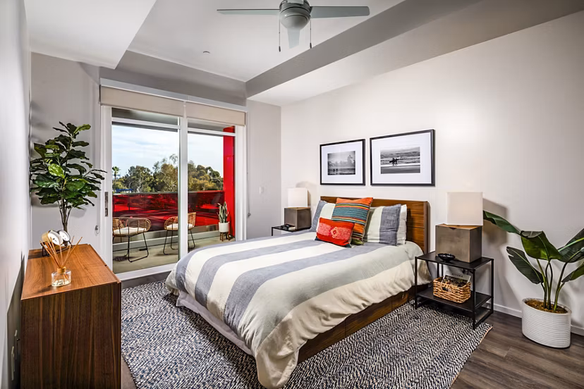 Elegant bedroom with large windows and modern decor in Burano Place Apartments