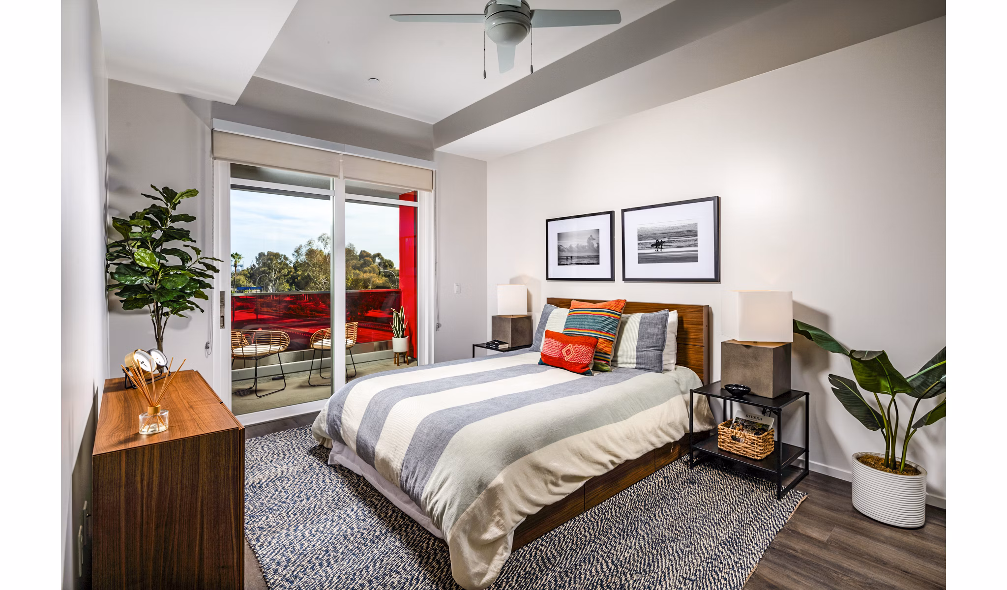 Elegant bedroom with large windows and modern decor in Burano Place Apartments