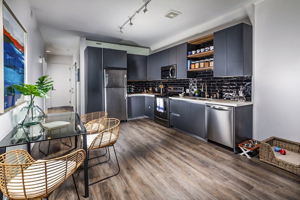 Modern kitchen with sleek countertops and stainless steel appliances at Burano Apartments