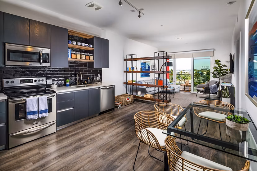 Modern kitchen with sleek appliances and granite countertops in Burano Apartments