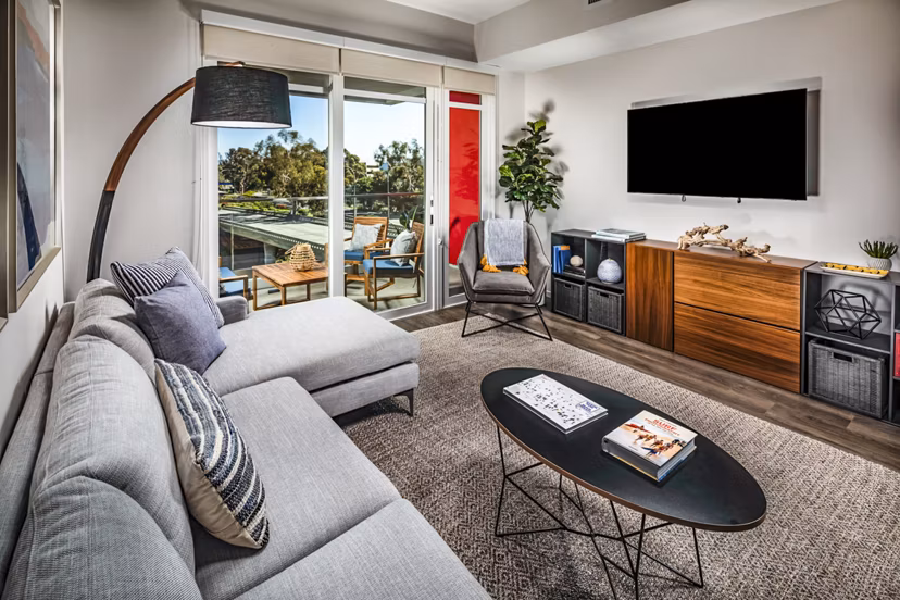Cozy living room with modern furnishings and natural light at Burano Apartments