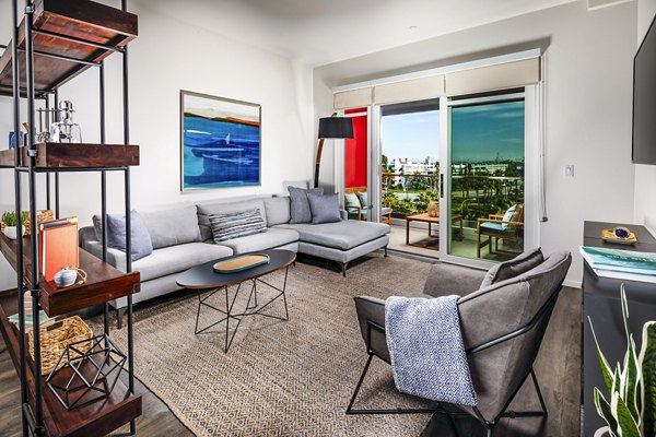 Living room with elegant decor and natural light at Burano Apartments