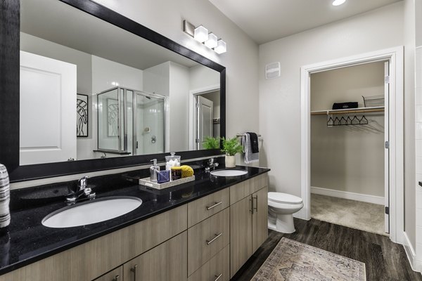 Modern bathroom with sleek fixtures and marble countertops in The Arnold Apartments, luxury living by Greystar