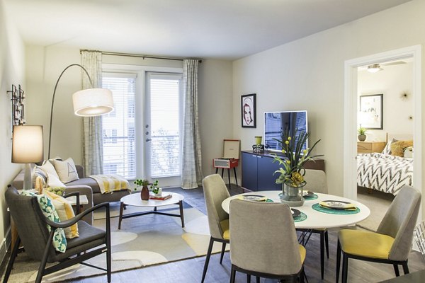 Dining area with modern furniture and chic lighting at The Arnold Apartments