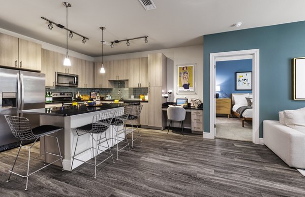 Modern kitchen with granite countertops at The Arnold Apartments, luxurious interiors for an elevated living experience