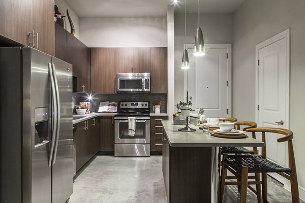 Spacious kitchen featuring modern appliances at The Arnold Apartments in luxury living space