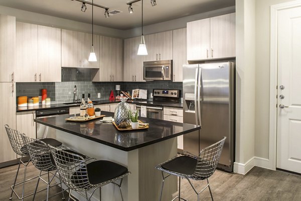 Modern kitchen with sleek cabinetry and stainless steel appliances at The Arnold Apartments