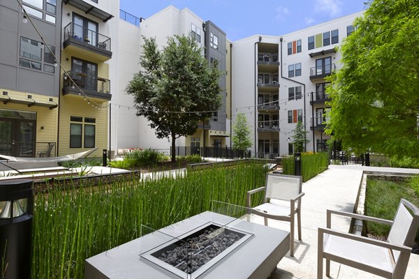 Cozy outdoor fire pit area with seating at The Arnold Apartments offering luxury living in the heart of the city