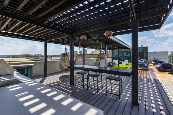 Outdoor grill area with modern seating at The Arnold Apartments