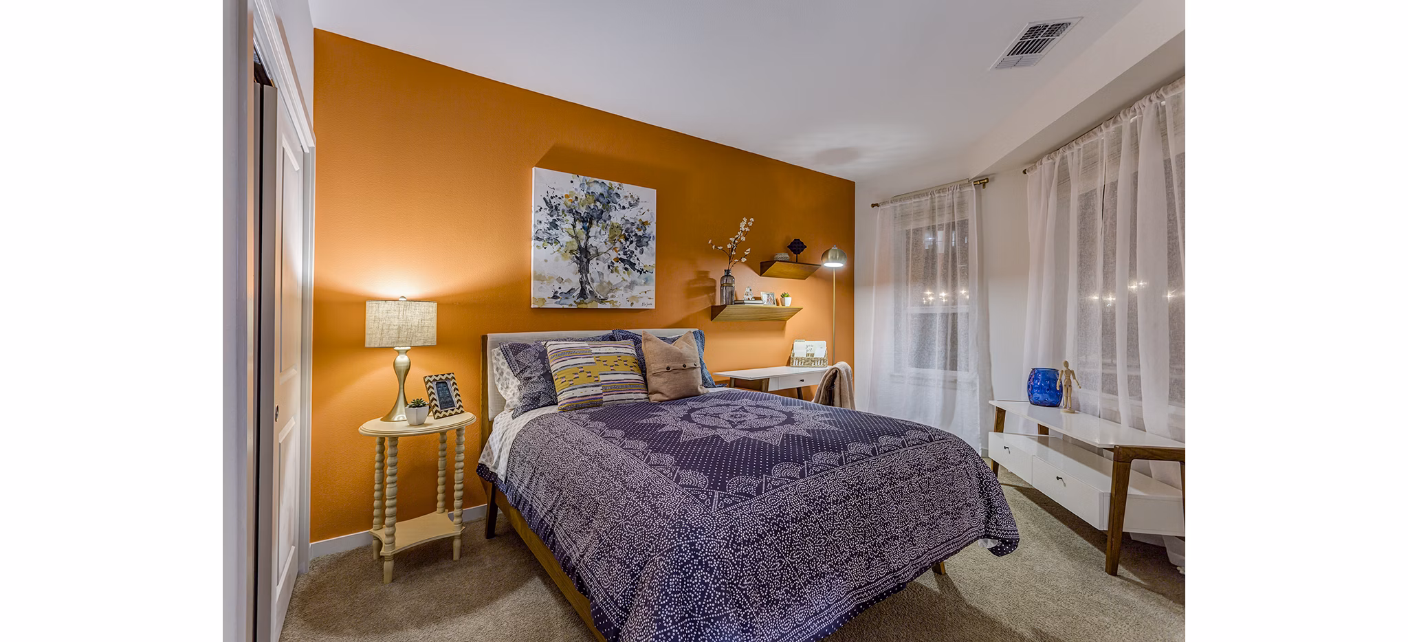 Venue on 16th Apartments: Cozy bedroom with modern decor and ample natural light