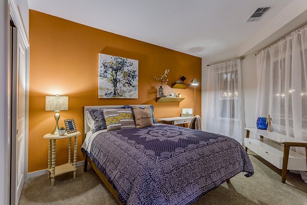 Venue on 16th Apartments: Cozy bedroom with modern decor and ample natural light