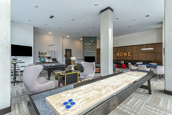 Modern game room with billiards and lounge seating at Venue on 16th Apartments
