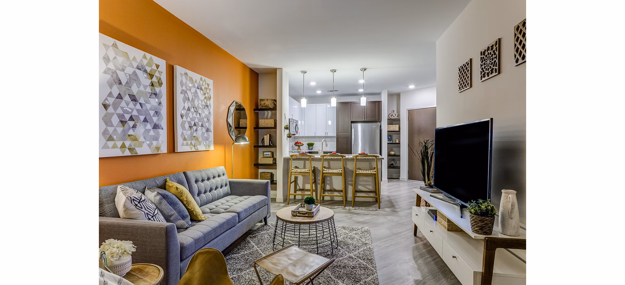 Inviting living room with modern decor and ample natural light at Venue on 16th Apartments