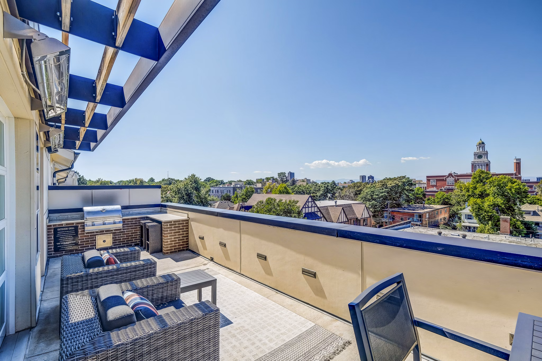 Grill and patio area with seating at Venue on 16th Apartments, ideal for outdoor gatherings and relaxation
