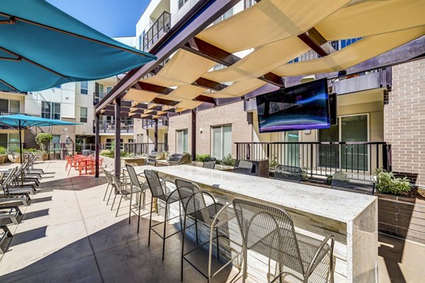 Outdoor grill and patio area at Venue on 16th Apartments, perfect for dining and relaxation