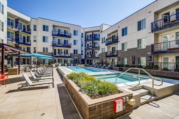 Luxurious rooftop pool with cityscape views at Venue on 16th Apartments, offering relaxation and entertainment for residents