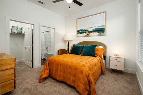 Cozy bedroom with modern decor at The Oliver Apartments